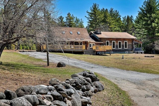399 Loch Muller Rd, Schroon, NY 12870 - rear view of property featuring log exterior, a deck, asphalt driveway, a yard, and a chimney