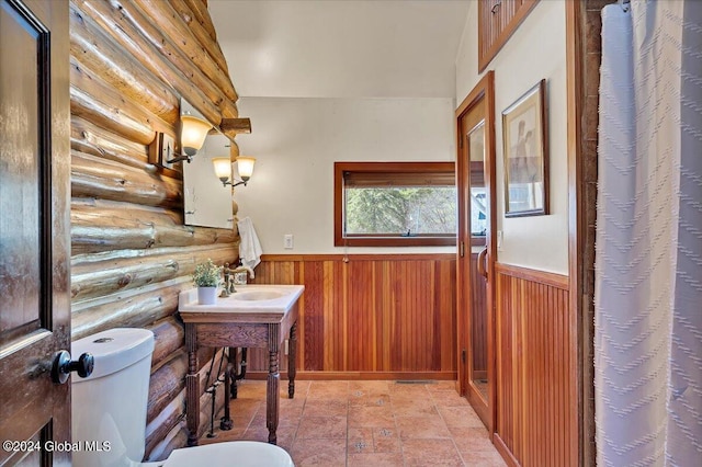 399 Loch Muller Rd, Schroon, NY 12870 - bathroom featuring log walls, wainscoting, toilet, vanity, and curtained shower