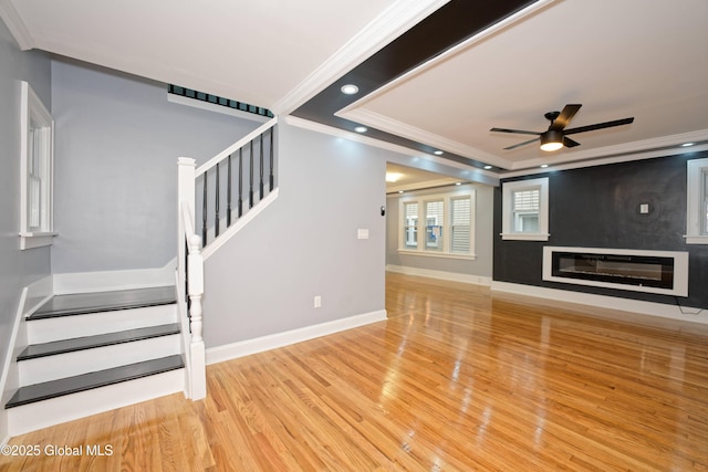 35 Wallace St, Scotia, NY 12302 - unfurnished living room with stairway, ornamental molding, wood finished floors, ceiling fan, and baseboards