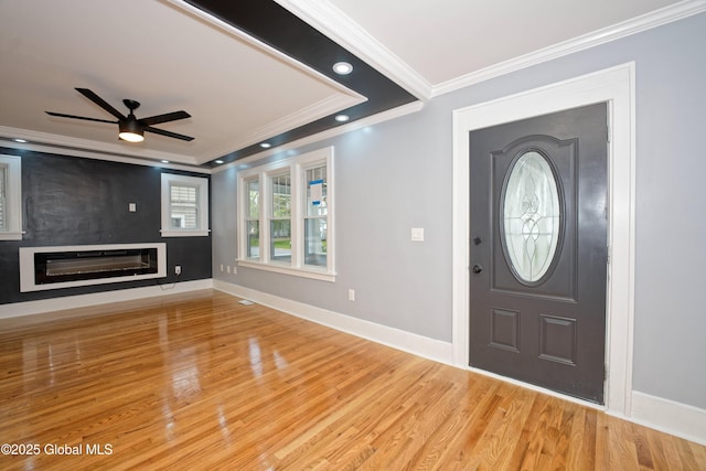 35 Wallace St, Scotia, NY 12302 - foyer with ornamental molding, a ceiling fan, a glass covered fireplace, wood finished floors, and baseboards