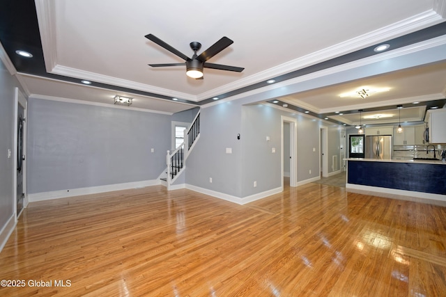 35 Wallace St, Scotia, NY 12302 - unfurnished living room with a ceiling fan, light wood finished floors, a sink, crown molding, and stairs