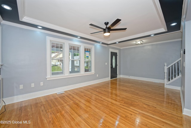35 Wallace St, Scotia, NY 12302 - unfurnished room featuring crown molding, a ceiling fan, stairway, a raised ceiling, and wood finished floors