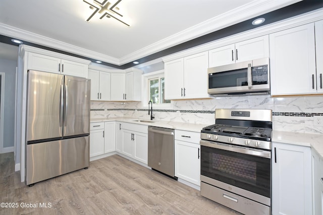 35 Wallace St, Scotia, NY 12302 - kitchen with appliances with stainless steel finishes, ornamental molding, a sink, white cabinets, and light wood-style floors