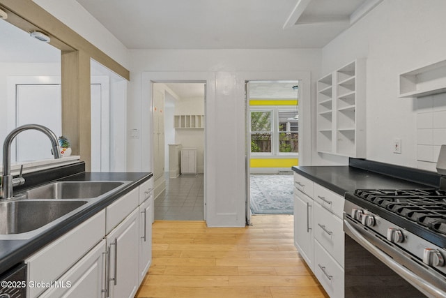 406 Northern Pines Rd, Wilton, NY 12831 - kitchen with stainless steel gas range, a sink, dark countertops, and white cabinets