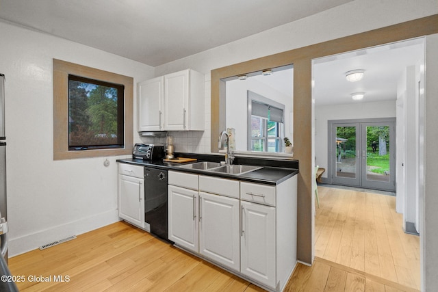406 Northern Pines Rd, Wilton, NY 12831 - kitchen with black dishwasher, a sink, dark countertops, and light wood-style floors
