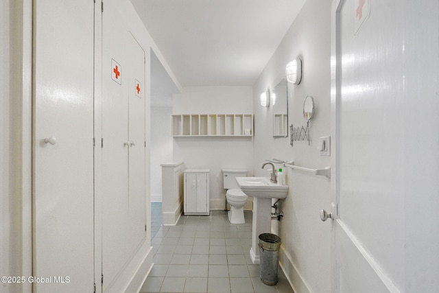 406 Northern Pines Rd, Wilton, NY 12831 - bathroom with tile patterned flooring, baseboards, a sink, and toilet