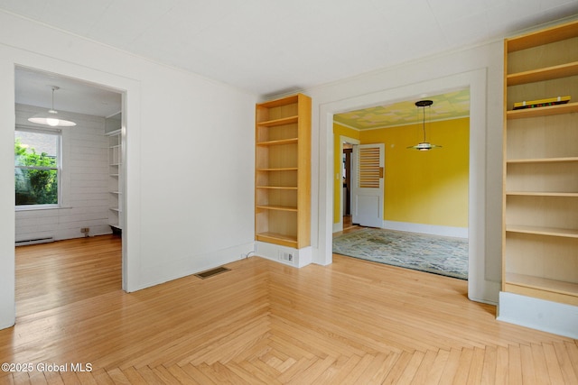 406 Northern Pines Rd, Wilton, NY 12831 - empty room with baseboard heating, baseboards, built in shelves, and ornamental molding