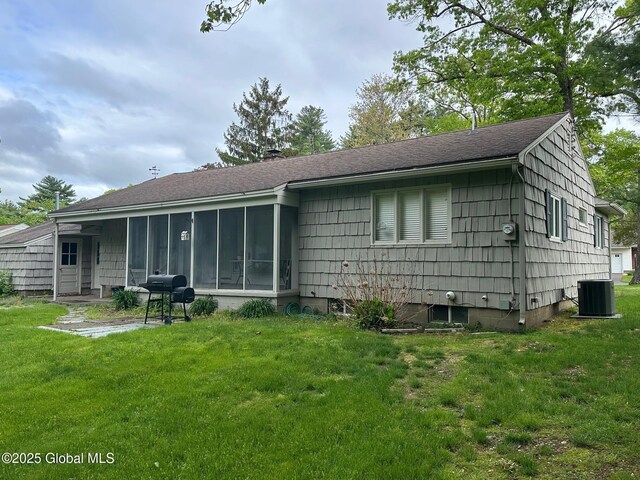 5 Wincrest Dr, Queensbury, NY 12804 - back of property featuring cooling unit, a sunroom, a lawn, and roof with shingles
