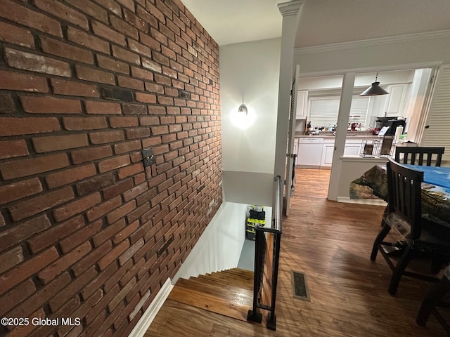 5 Wincrest Dr, Queensbury, NY 12804 - stairway featuring brick wall, wood finished floors, and ornamental molding