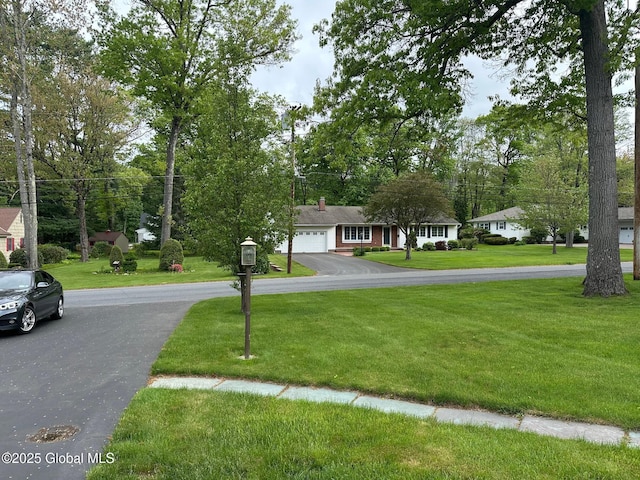 5 Wincrest Dr, Queensbury, NY 12804 - view of front of home featuring driveway, a front lawn, and a garage