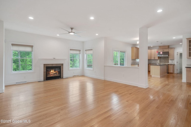 45 Tamarack Ln, Colonie, NY 12309 - unfurnished living room featuring healthy amount of natural light, light wood-type flooring, a ceiling fan, a fireplace, and recessed lighting