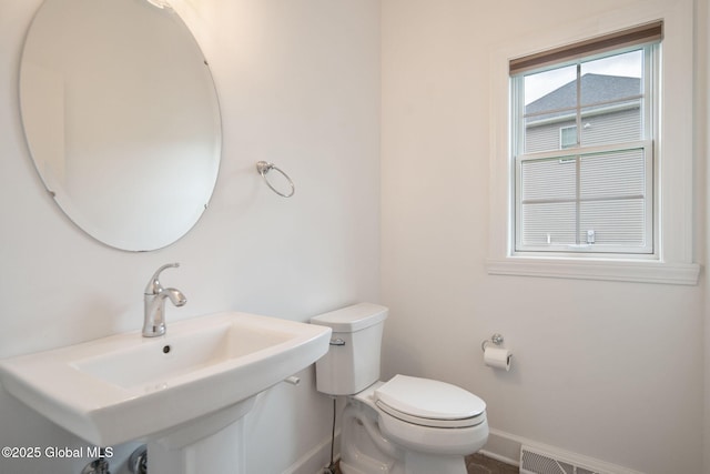 45 Tamarack Ln, Colonie, NY 12309 - half bathroom with baseboards, toilet, and a sink