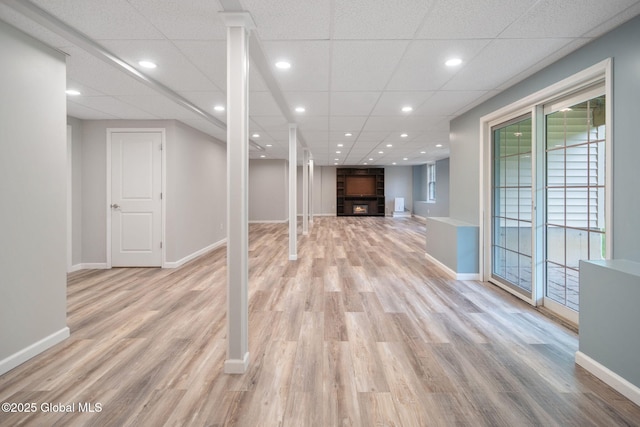45 Tamarack Ln, Colonie, NY 12309 - basement featuring light wood-style flooring, a paneled ceiling, baseboards, recessed lighting, and a large fireplace
