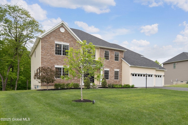 45 Tamarack Ln, Colonie, NY 12309 - colonial home with a front lawn, asphalt driveway, an attached garage, and brick siding