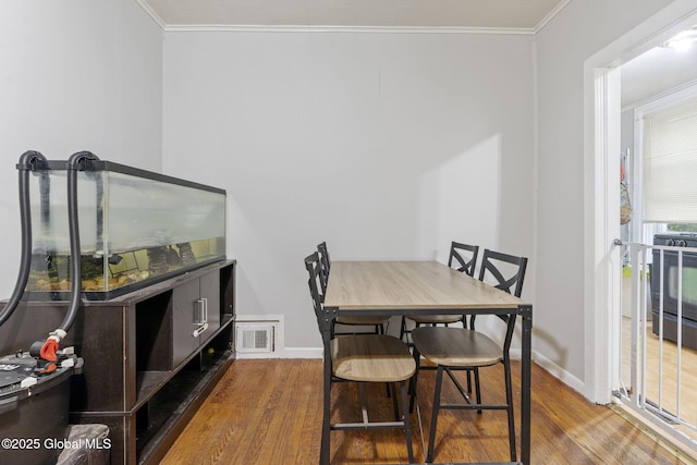 797 Eastern Ave, Schenectady, NY 12308 - dining room featuring wood finished floors, ornamental molding, and baseboards