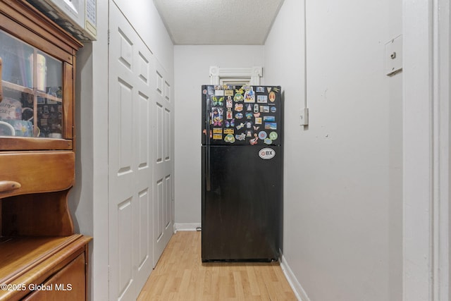 797 Eastern Ave, Schenectady, NY 12308 - hallway with light wood-type flooring, baseboards, and a textured ceiling