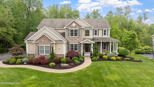 41 Tipperary Way, Clifton Park, NY 12019 - view of front of house with stone siding, a front lawn, and a shingled roof