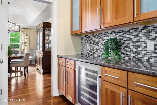 41 Tipperary Way, Clifton Park, NY 12019 - bar featuring wine cooler, dark wood-style flooring, backsplash, a chandelier, and a raised ceiling