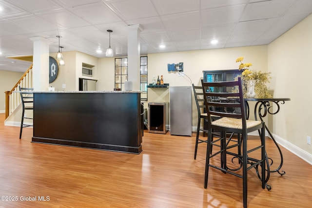 41 Tipperary Way, Clifton Park, NY 12019 - kitchen with baseboards, light wood finished floors, ornate columns, recessed lighting, and light stone countertops