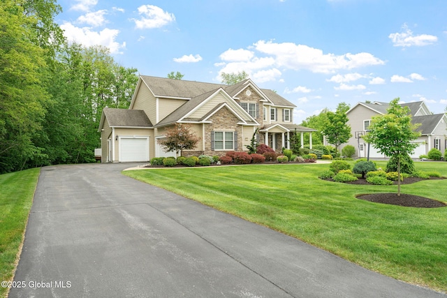 41 Tipperary Way, Clifton Park, NY 12019 - view of front of home featuring a garage, driveway, a front yard, and stone siding