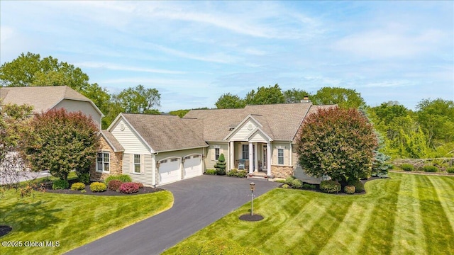 19 Hidden Farm Ln, Halfmoon, NY 12118 - view of front of house featuring an attached garage, driveway, a front lawn, and a chimney