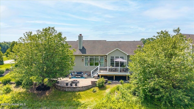 19 Hidden Farm Ln, Halfmoon, NY 12118 - rear view of house featuring a wooden deck, a patio area, an outdoor fire pit, and a chimney
