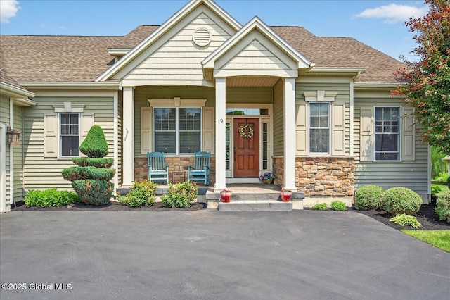 19 Hidden Farm Ln, Halfmoon, NY 12118 - craftsman house featuring a porch, stone siding, and a shingled roof