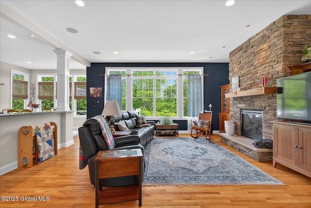 19 Hidden Farm Ln, Halfmoon, NY 12118 - living room with ornate columns, baseboards, light wood-type flooring, a stone fireplace, and recessed lighting