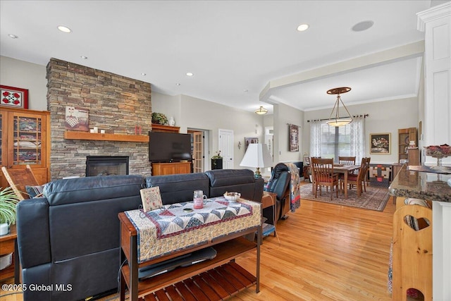 19 Hidden Farm Ln, Halfmoon, NY 12118 - living room featuring light wood-style floors, a stone fireplace, recessed lighting, and ornamental molding