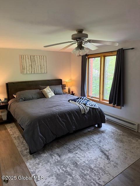 30 Freebern Rd Unit 30C, Johnsburg, NY 12853 - bedroom with a baseboard heating unit, wood finished floors, and ceiling fan
