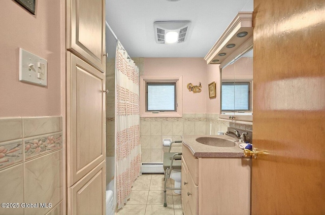 8 Adams Ave, East Greenbush, NY 12144 - full bathroom featuring vanity, a baseboard radiator, tile walls, shower / bath combo, and tile patterned flooring