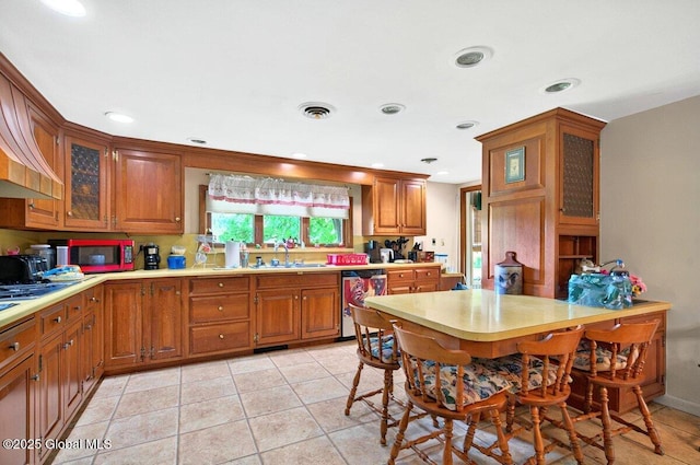 8 Adams Ave, East Greenbush, NY 12144 - kitchen featuring dishwasher, a sink, light countertops, brown cabinets, and recessed lighting