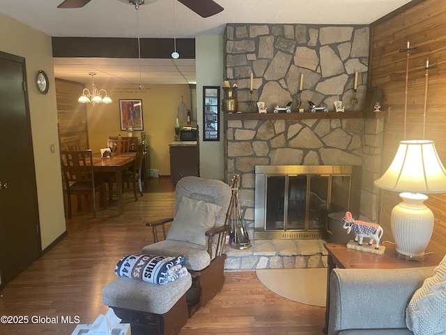 11K Overlook Ln, Warrensburg, NY 12817 - living area featuring wood finished floors, a ceiling fan, a fireplace, and a chandelier