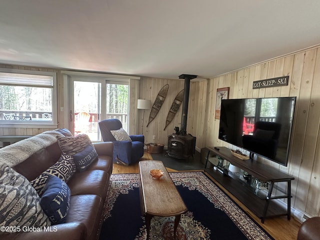 34 Park Rd, Johnsburg, NY 12843 - living room featuring a wood stove, wooden walls, and wood finished floors
