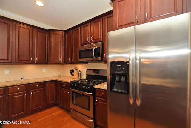 509 Lois Ln, Niskayuna, NY 12304 - kitchen featuring appliances with stainless steel finishes, light stone countertops, light wood-type flooring, backsplash, and recessed lighting