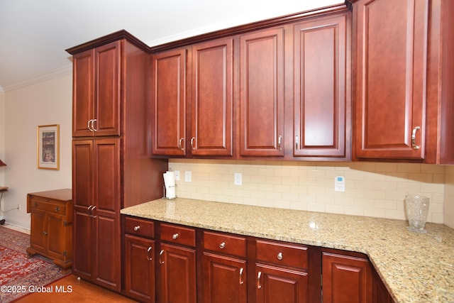 509 Lois Ln, Niskayuna, NY 12304 - kitchen featuring reddish brown cabinets, backsplash, ornamental molding, and light stone countertops