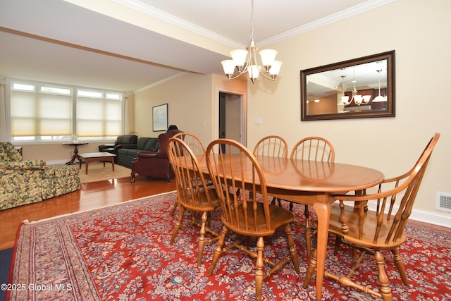 509 Lois Ln, Niskayuna, NY 12304 - dining space with a chandelier, crown molding, wood finished floors, and baseboards
