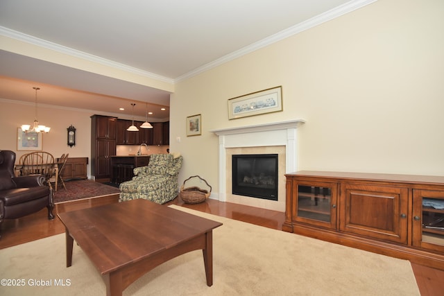 509 Lois Ln, Niskayuna, NY 12304 - living room featuring wood finished floors, crown molding, a chandelier, a glass covered fireplace, and baseboards