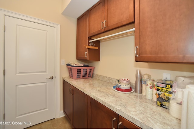 509 Lois Ln, Niskayuna, NY 12304 - kitchen with light countertops, brown cabinets, and light tile patterned floors