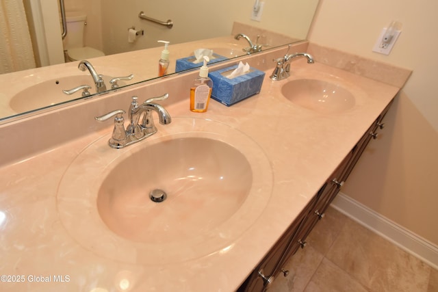 509 Lois Ln, Niskayuna, NY 12304 - bathroom featuring toilet, tile patterned floors, double vanity, and baseboards