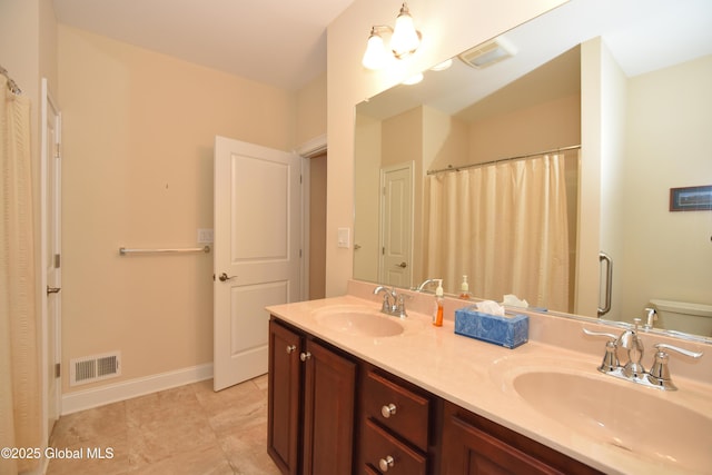 509 Lois Ln, Niskayuna, NY 12304 - full bathroom featuring double vanity, toilet, baseboards, and tile patterned flooring