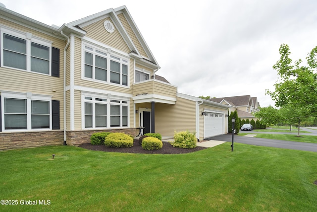 509 Lois Ln, Niskayuna, NY 12304 - view of front of property featuring driveway, a front lawn, a balcony, an attached garage, and stone siding