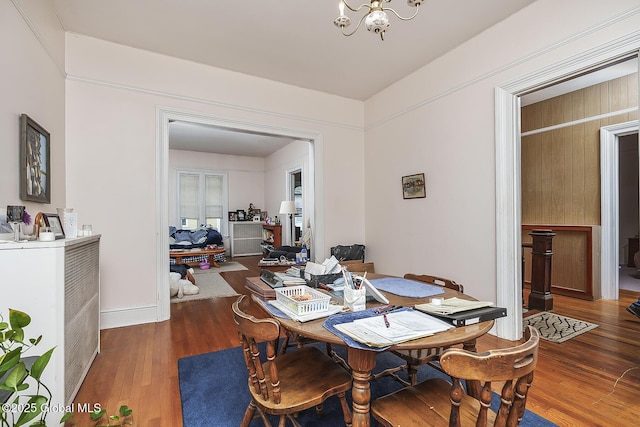 1466 3rd St, Rensselaer, NY 12144 - dining area with a chandelier, wood finished floors, and baseboards