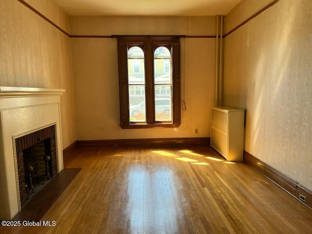 1466 3rd St, Rensselaer, NY 12144 - unfurnished living room featuring hardwood / wood-style floors and a brick fireplace