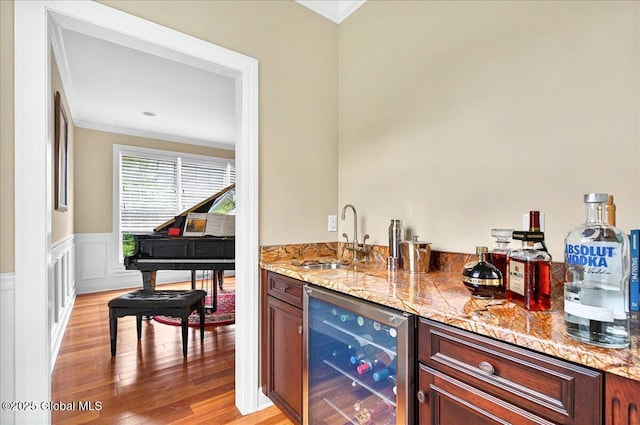 779 Waldens Pond, Guilderland, NY 12203 - indoor wet bar featuring beverage cooler, crown molding, and light wood-style floors