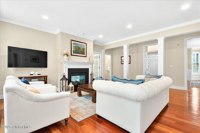 779 Waldens Pond, Guilderland, NY 12203 - living area with ornate columns, wood finished floors, crown molding, baseboards, and a glass covered fireplace
