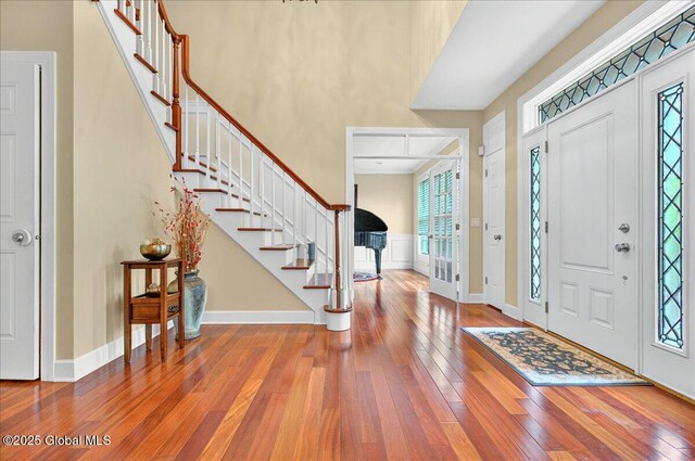779 Waldens Pond, Guilderland, NY 12203 - foyer entrance featuring wood-type flooring, stairway, baseboards, and a towering ceiling