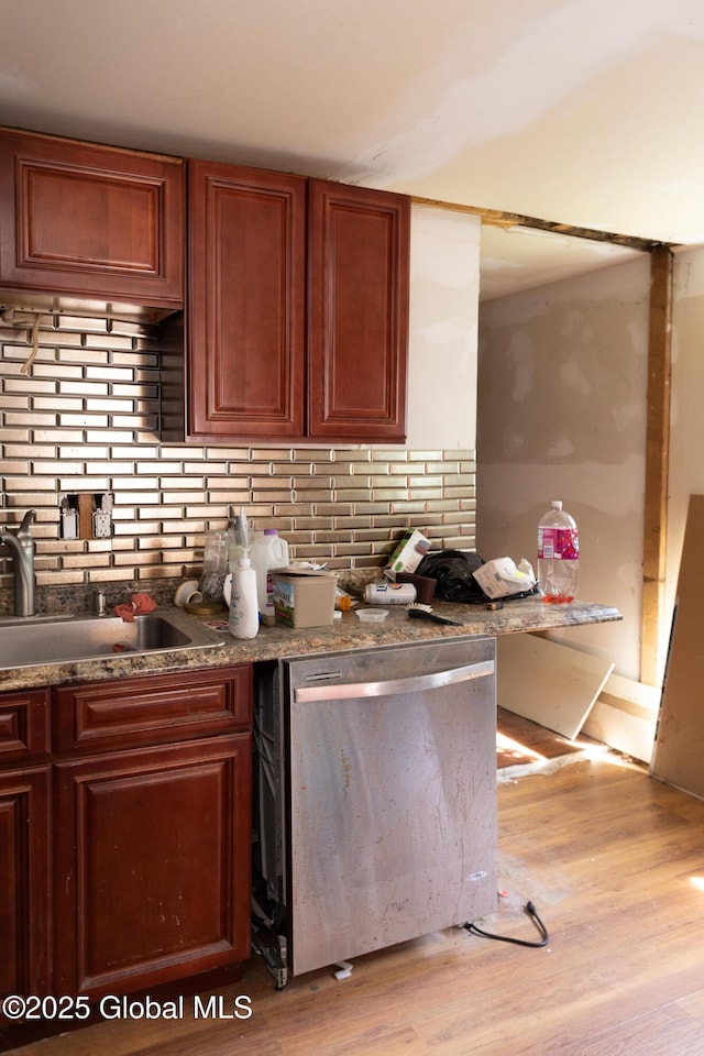 1864 7th Ave, Watervliet, NY 12189 - kitchen with dishwasher, a sink, light wood-type flooring, backsplash, and dark countertops