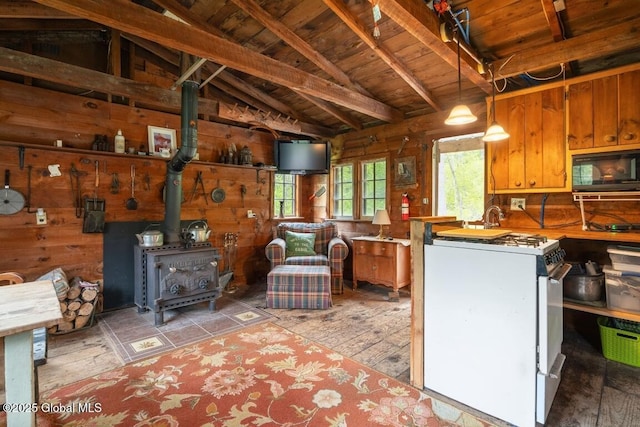 429 Posson Hill Rd, Middleburgh, NY 12122 - kitchen with black microwave, white gas stove, wooden walls, healthy amount of natural light, and wood ceiling