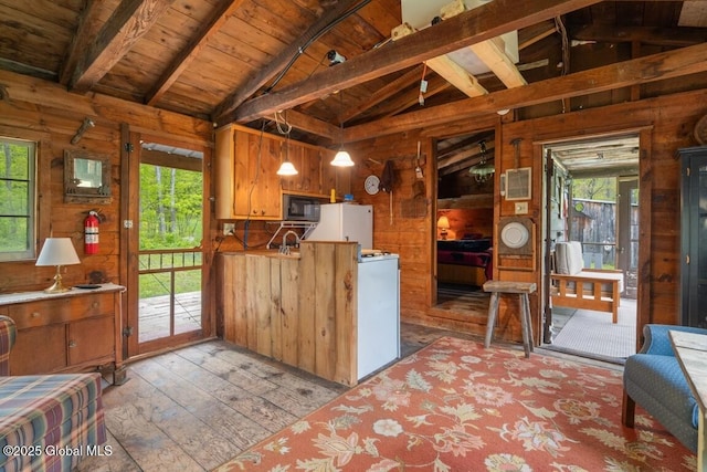 429 Posson Hill Rd, Middleburgh, NY 12122 - kitchen featuring black microwave, light wood-style floors, healthy amount of natural light, wood walls, and wooden ceiling